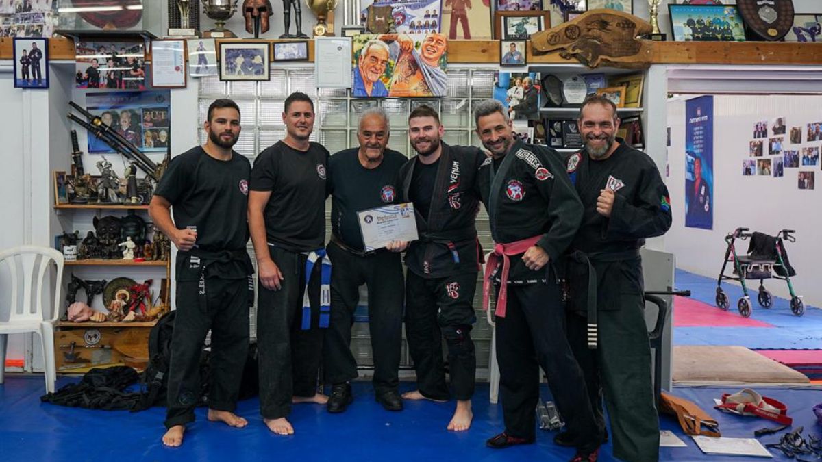 Krav Maga instructor being presented with their 3rd dan black belt during a ceremony from Dennis Hanover.