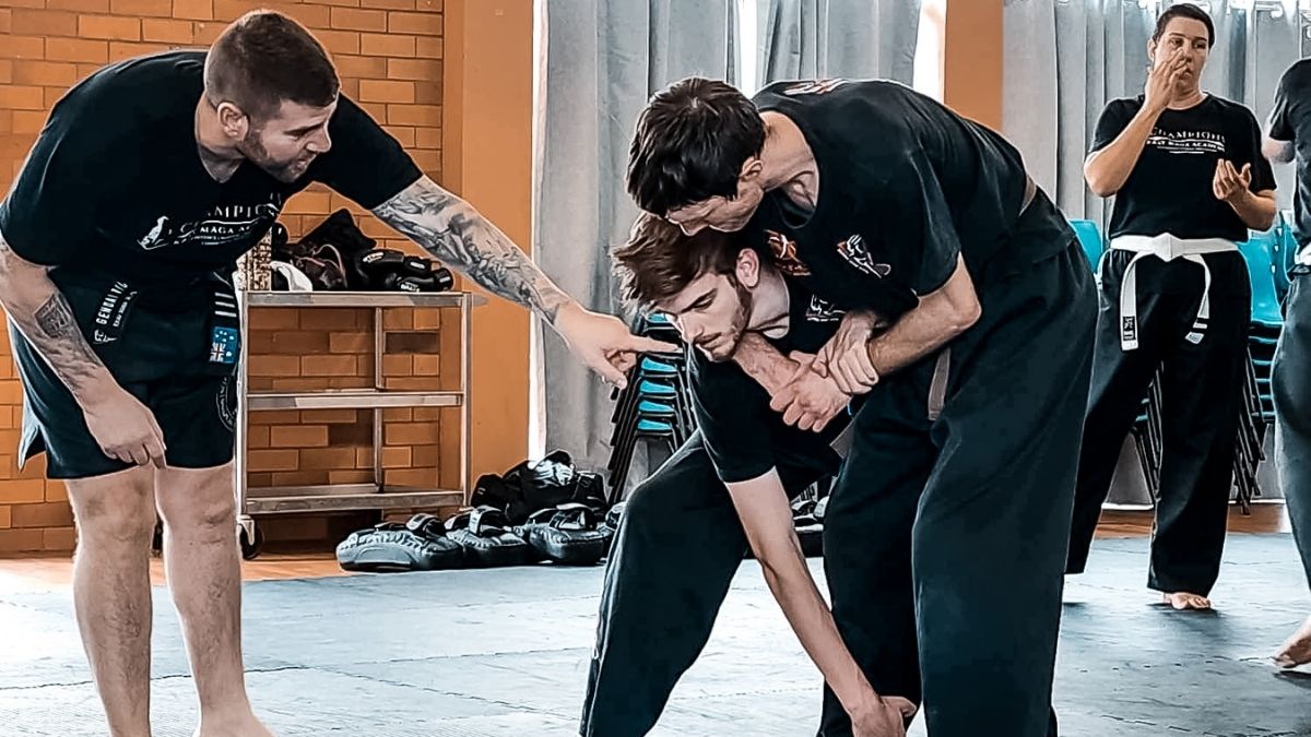 Instructor demonstrating Krav Maga and MMA techniques to students. Learn Krav Maga now!